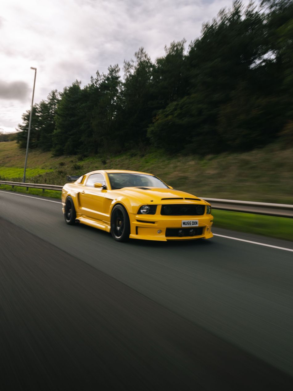 Yellow Ford Mustang on the road