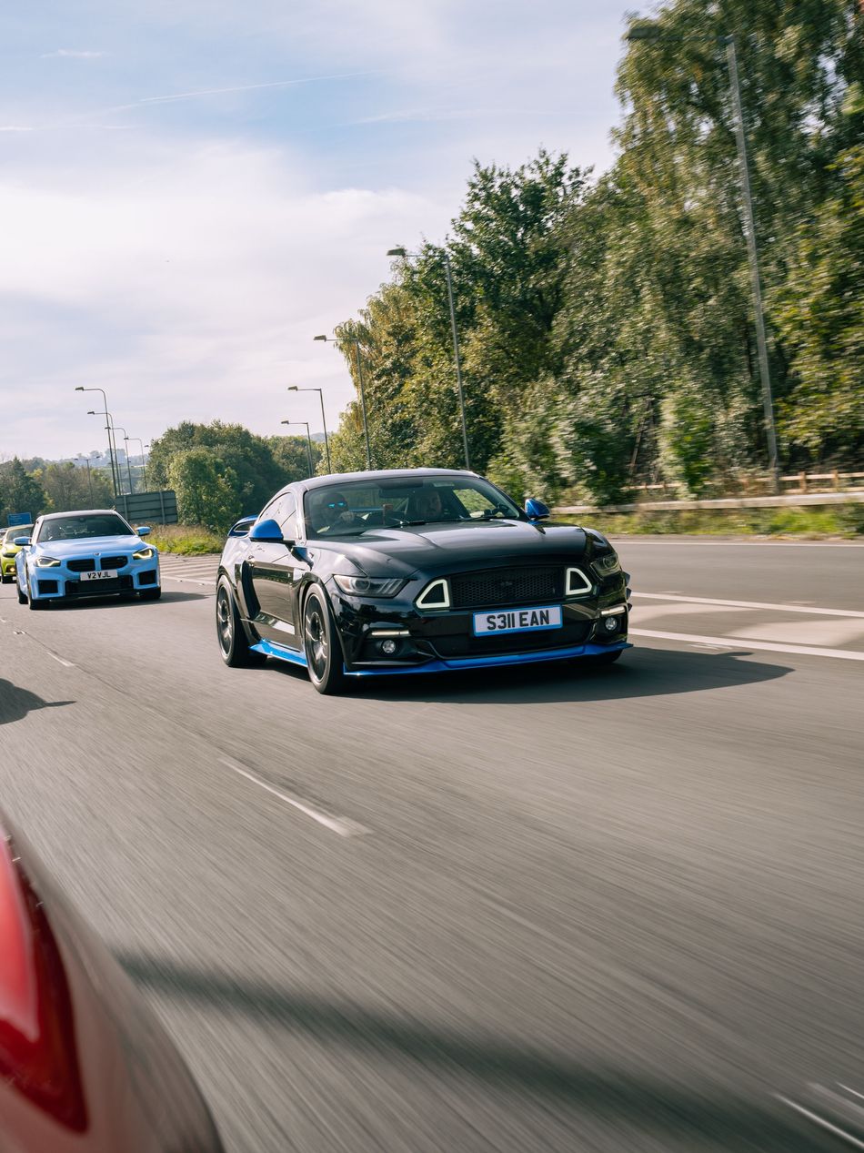 Black Ford Mustang and BMW M2 in convoy